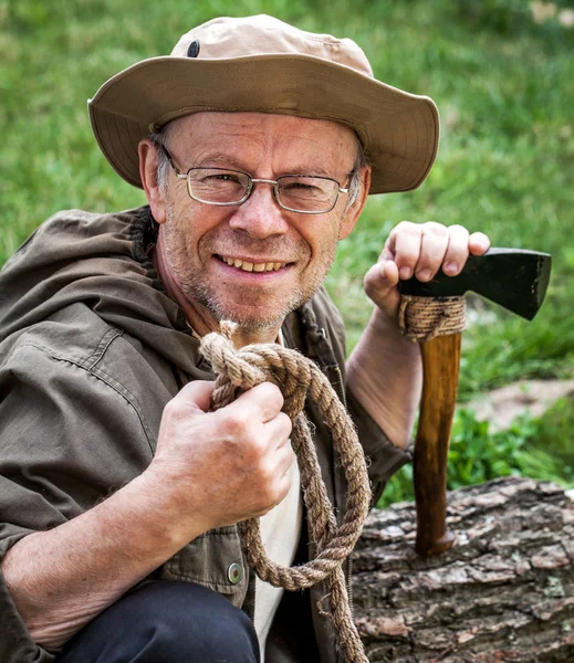 Senior tourist man with axe — Stock Photo, Image