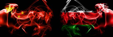 Flags of China, Chinese vs Oman. Smoke flag placed side by side on black background. 