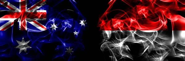 オーストラリア オーストラリア対インドネシア インドネシアの旗 黒地に煙旗を並べて — ストック写真