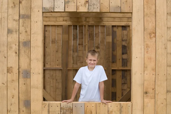 Boy stood in the window opening — Stock Photo, Image