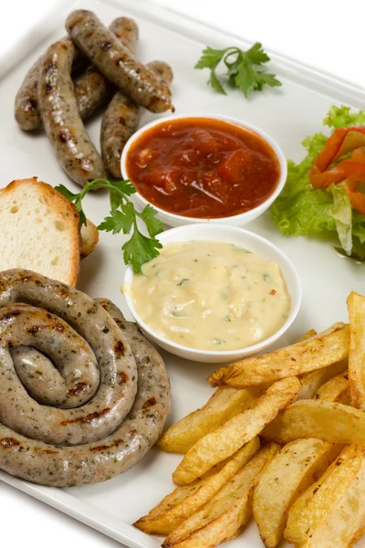 Bavarian sausages on the grill, french fries — Stock Photo, Image