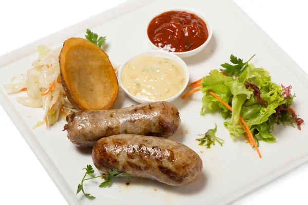 German sausages with roasted potatoes and sauerkraut. — Stock Photo, Image