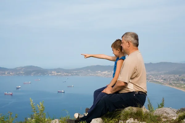 Grandfather and grandson at the top of the mountain. — Stock Photo, Image