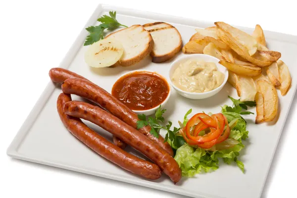 Spicy smoked sausage with cheese and fry potatoes in a pan. — Stock Photo, Image