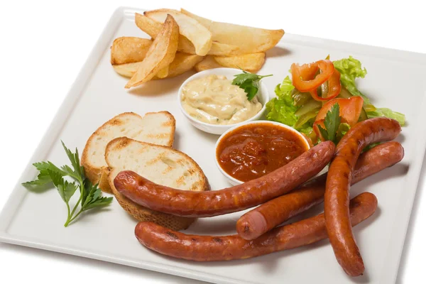 Spicy smoked sausage with cheese and fry potatoes in a pan. — Stock Photo, Image