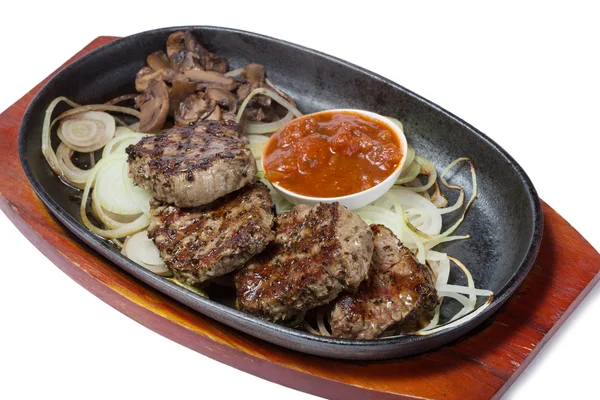 Medallions of beef with mushrooms in the frying pan. — Stock Photo, Image