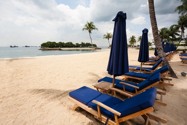 Ligstoelen op het strand van sentosa eiland in singapore. — Stockfoto
