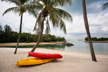 Boats on the beach of Sentosa Island in Singapore. clipart