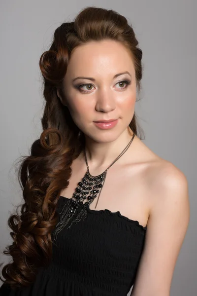 Elegant girl in a black dress — Stock Photo, Image