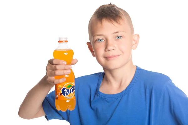 Boy holding a bottle of Fanta — Stock Photo, Image