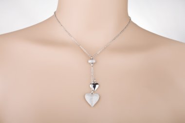 Silver necklace with two heart pendants on a mannequin clipart
