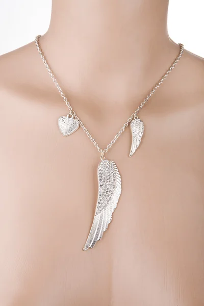 Silver necklace with angel wing and heart on a mannequin — Stock Photo, Image