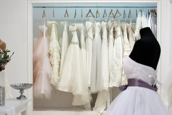 Wedding dresses on hangers in the showroom — Stock Photo, Image