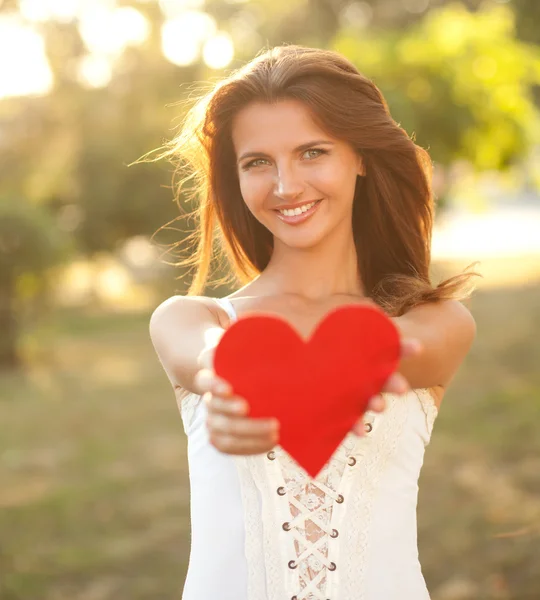 Woman with red heart Stock Picture
