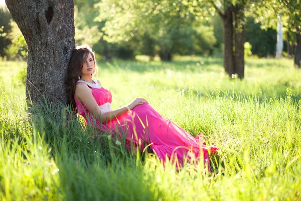 Woman in a long pink dress — Stock Photo, Image