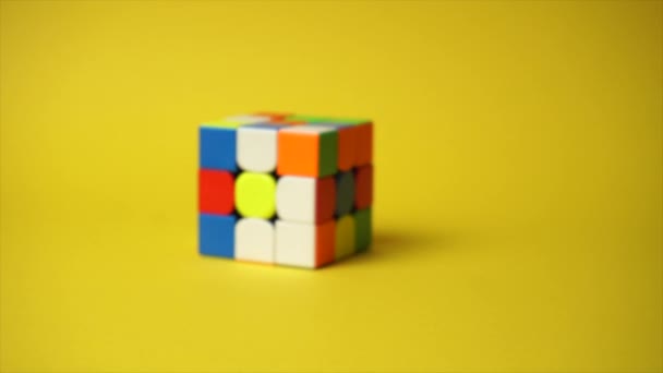 Rubiks cube at yellow background — Wideo stockowe