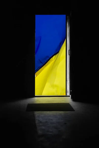 Opened door with Ukrainian flag behind it — 스톡 사진