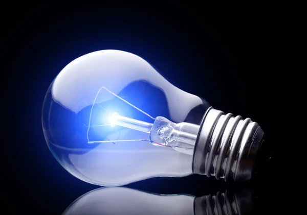 Photo of light bulb on black — Stock Photo, Image