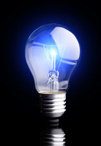 Photo of light bulb on black background — Stock Photo, Image