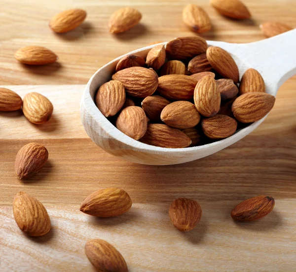 Almonds on wooden background — Stock Photo, Image