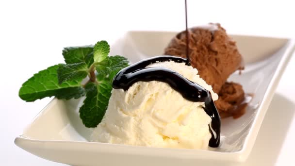 Pouring chocolate syrup over ice cream — Stock Video