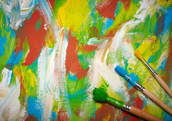 Paintbrushes on abstract grange background — Stock Photo, Image