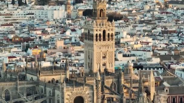 Aerial tele shot of gothic cathedral in Seville, Andalusia, Spain. Famous Giralda bell tower, Sevilla - capital city of Spains Andalusia region — Stock Video