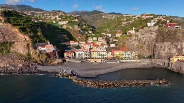 Madeira Adası, Ponta do Sol 'un hava manzarası. Etrafı renkli evler ve dağlarla çevrili rahat bir tatil köyü. Madeira, Portekiz