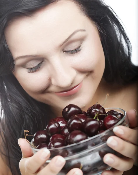 Woman with cherries over white