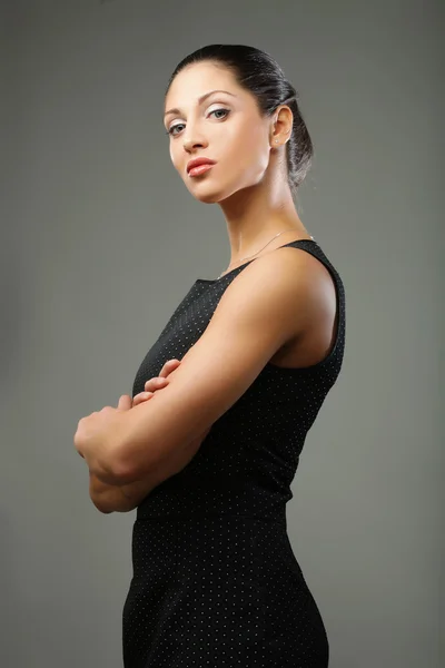 Beautiful sporty woman in black dress — Stock Photo, Image