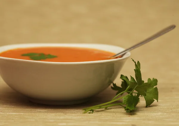 Pumpkin soup in white bowl with parsley — Stock Photo, Image