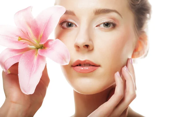 Beauty face of the young woman with pink lily — Stock Photo, Image