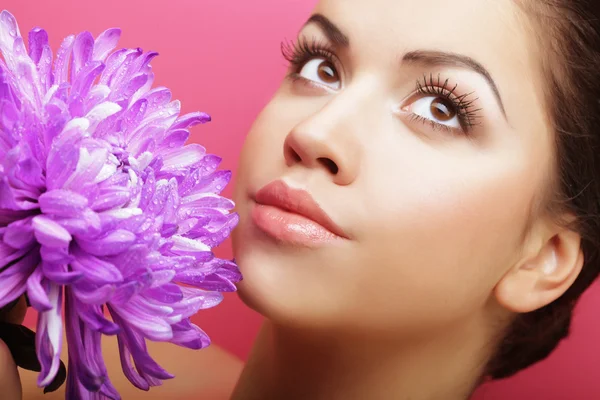 Beautiful woman with big purple flower — Stock Photo, Image