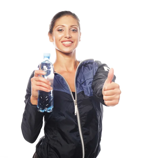 Smiling young sporty woman with water — Stock Photo, Image