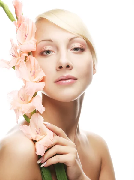 Woman with gladiolus flowers in her hands — Stock Photo, Image