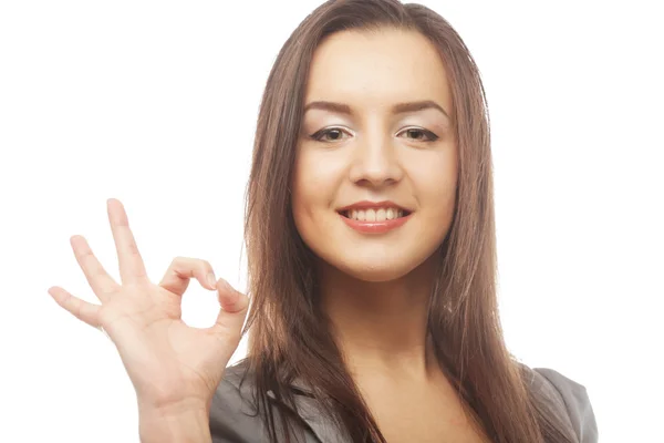 Happy businesswoman making an ok sign — Stock Photo, Image