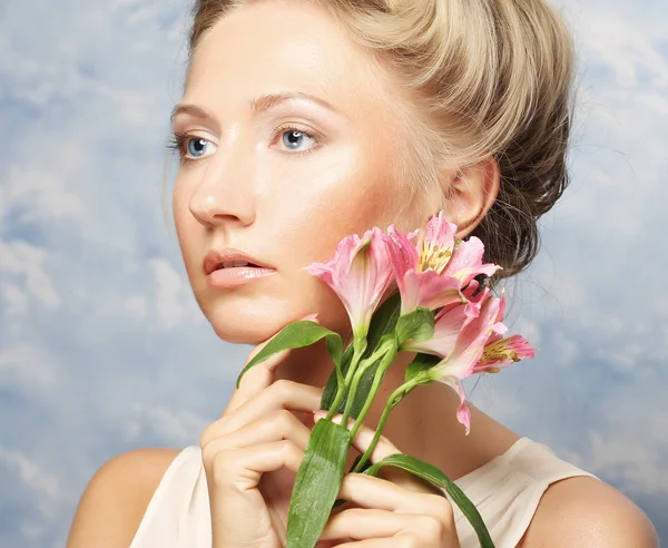 Junge schöne Frau mit rosa Blume — Stockfoto