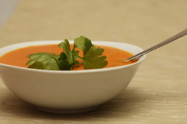 Pumpkin soup in white bowl with parsley — Stock Photo, Image