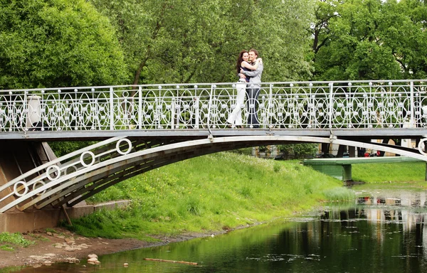 Couple walking on bridge in park — Stock Photo, Image