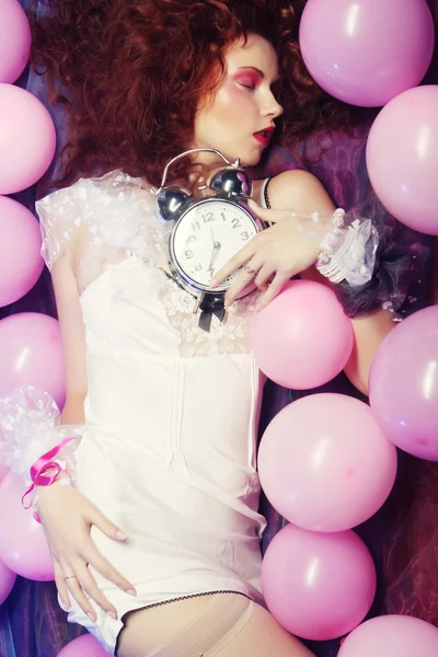 Woman lying on floor among balloons — Stock Photo, Image