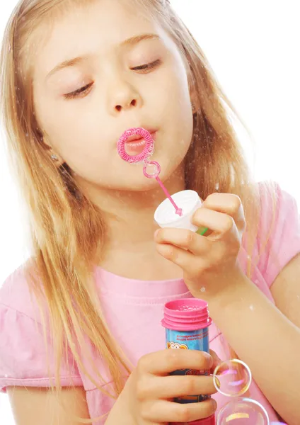 Funny lovely little girl blowing soap bubbles — Stock Photo, Image