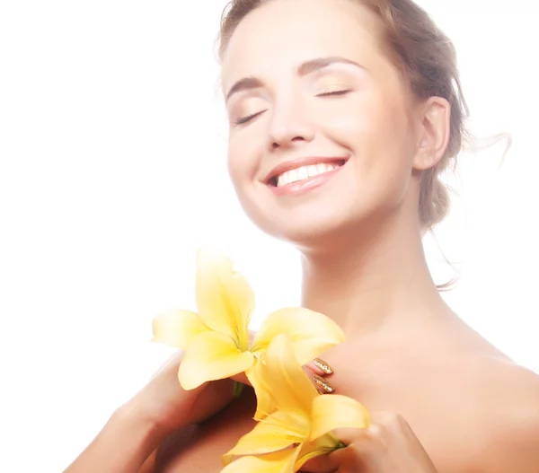 Young girl with yellow lily laughs Royalty Free Stock Images