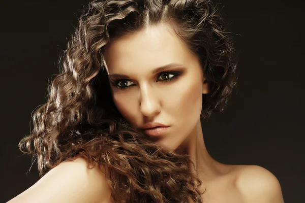 Beautiful woman with long curly hairs — Stock Photo, Image