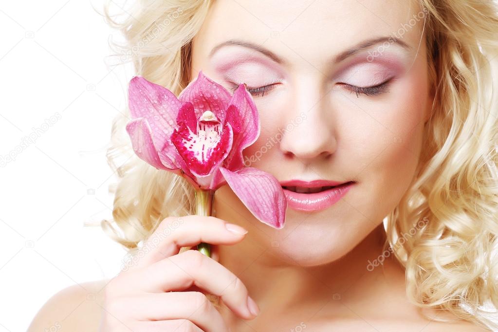 Young beautiful woman with pink flower
