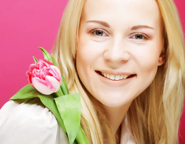 Blond woman with pink tulip — Stock Photo, Image