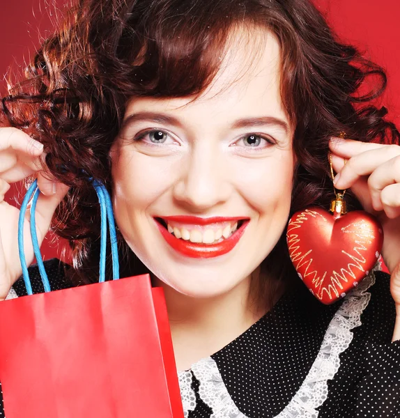 Happy woman with shopping bag and gift. — Stock Photo, Image