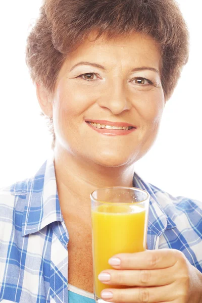 Mature woman holding a glass of orange juice — Stock Photo, Image
