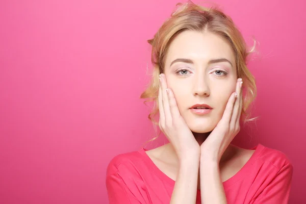 Young woman over pink background — Stok fotoğraf