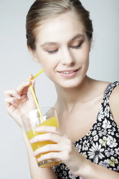 Молода жінка з апельсиновим соком — стокове фото
