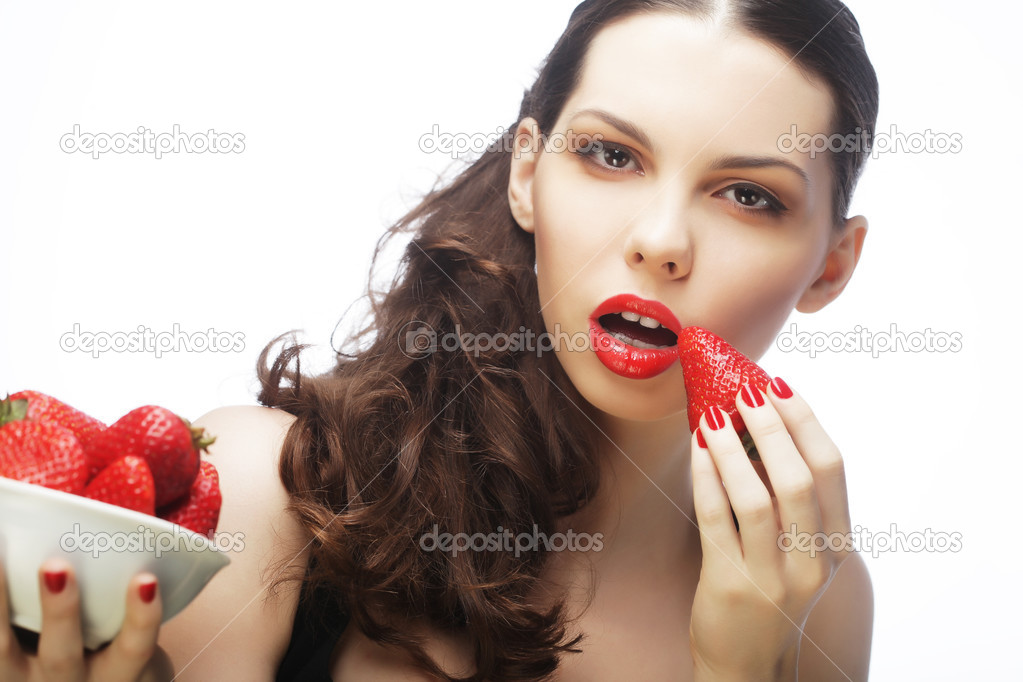 Sexy lady holding a juicy strawberry